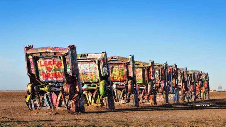 Brightly painted Cadillacs lined up at Cadillac Ranch near Amarillo, Texas Brightly painted Cadillacs lined up at Cadillac Ranch near Amarillo, Texas
