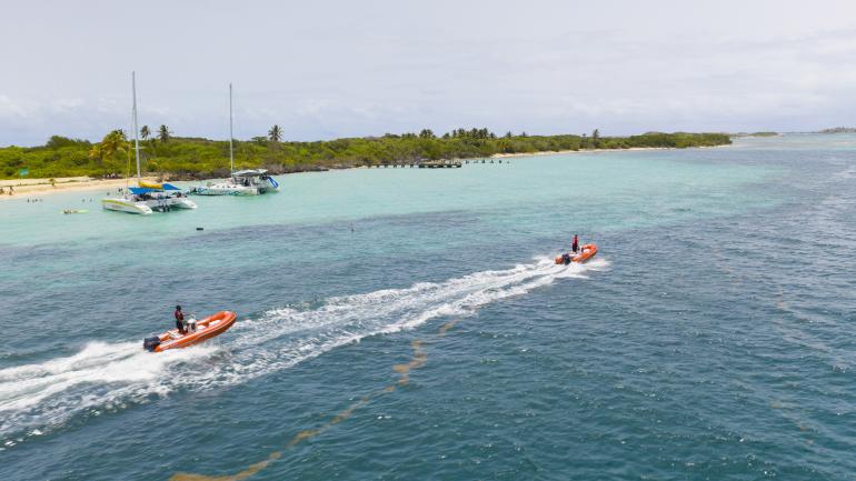 Cruising in personal speed boats through the blue waters of Cordillera Nature Reserve Cruising in personal speed boats through the blue waters of Cordillera Nature Reserve